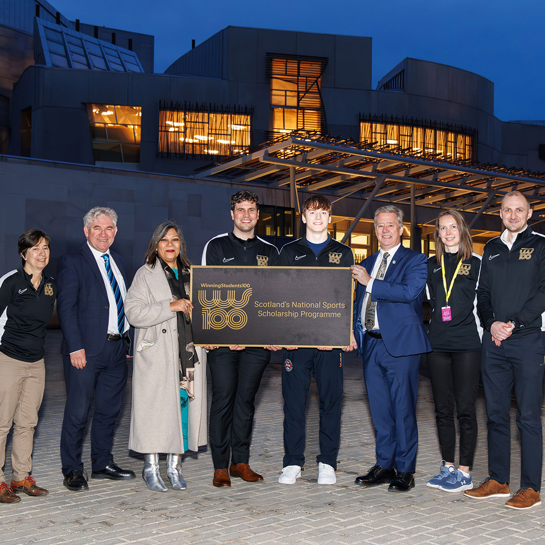 Staff and athletes of the Winning Students 100 Programme gather outside the Scottish Parliament to pose for a photo